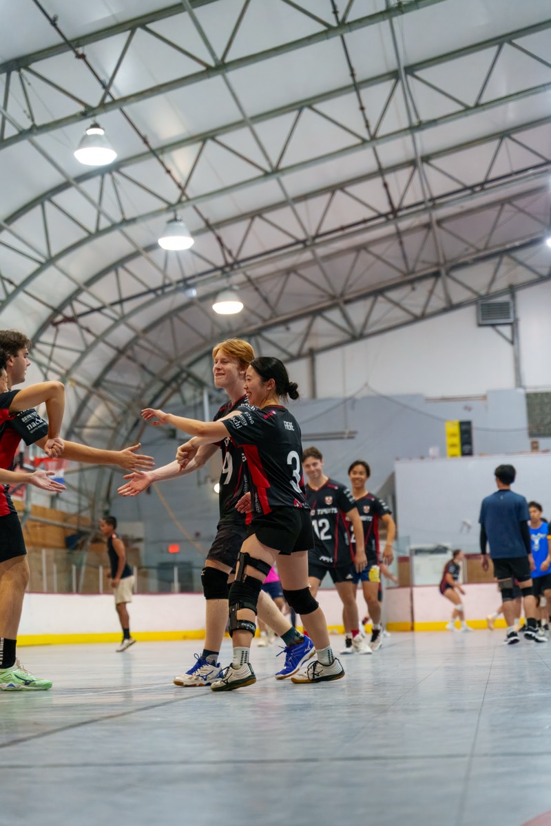 Teammates exchanging high fives after a point
